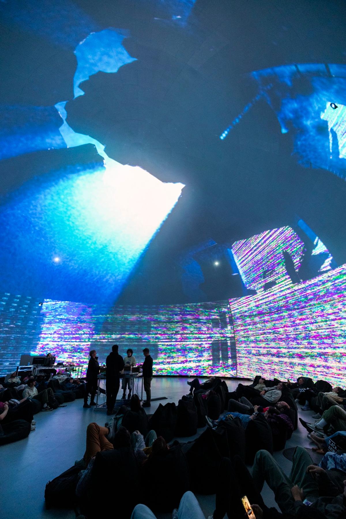 Blue cavern and glitched walls projected over the audience